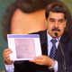 Venezuelan President Nicolas Maduro holding a copy of an alleged contract for U.S. mercenaries to overthrow the nation’s government.